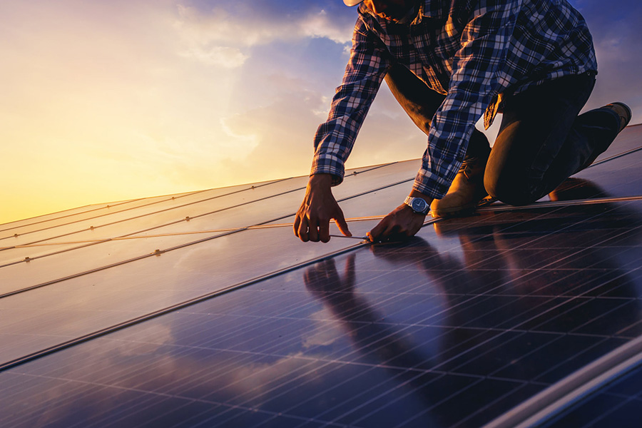 Electrician installing solar panels on a roof - Springfield, IL