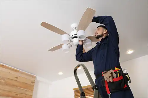 Ruby Electric, Inc.—An electrician repairs an indoor ceiling fan at a home in Springfield, IL.