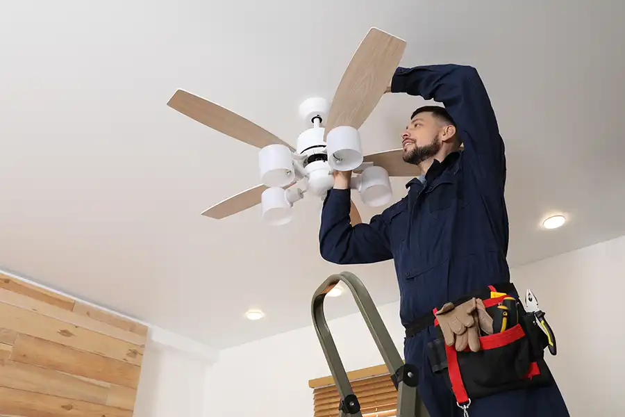Ruby Electric, Inc.—An electrician repairs an indoor ceiling fan at a home in Springfield, IL.
