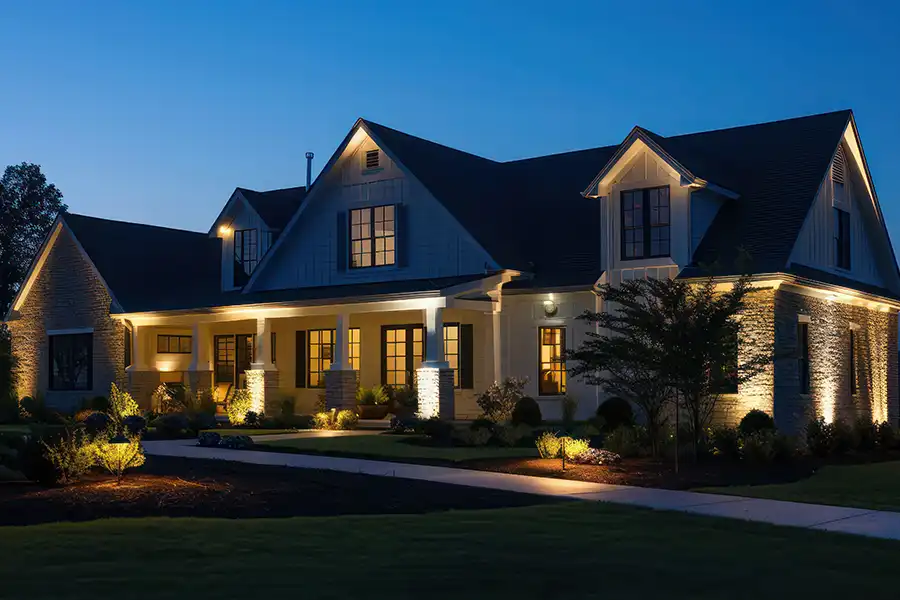 Ruby Electric, Inc.—A suburban home at night with multiple landscape lights to improve home security in Springfield, IL.